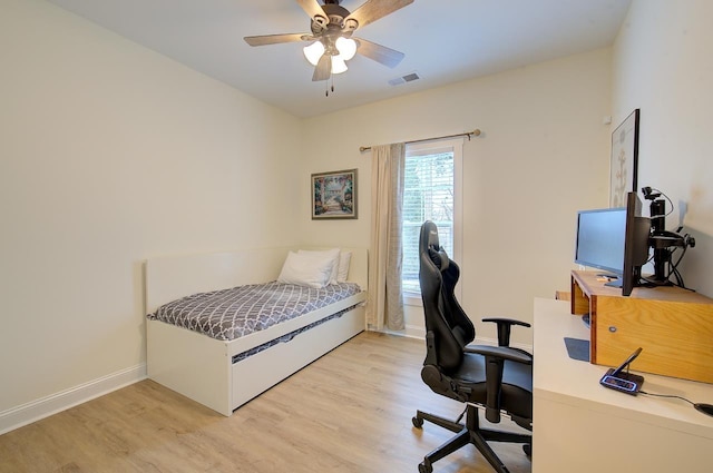 bedroom with baseboards, ceiling fan, visible vents, and light wood-style floors