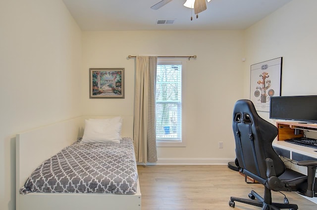 bedroom with baseboards, ceiling fan, visible vents, and light wood-style floors