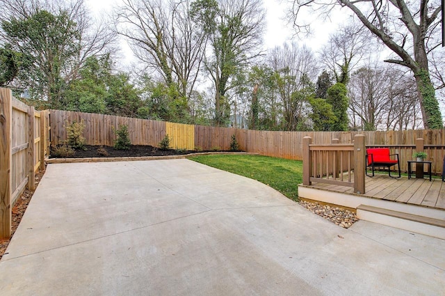 view of patio with a fenced backyard and a deck