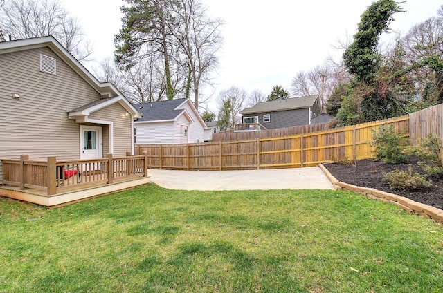 view of yard featuring a fenced backyard, a patio, and a wooden deck