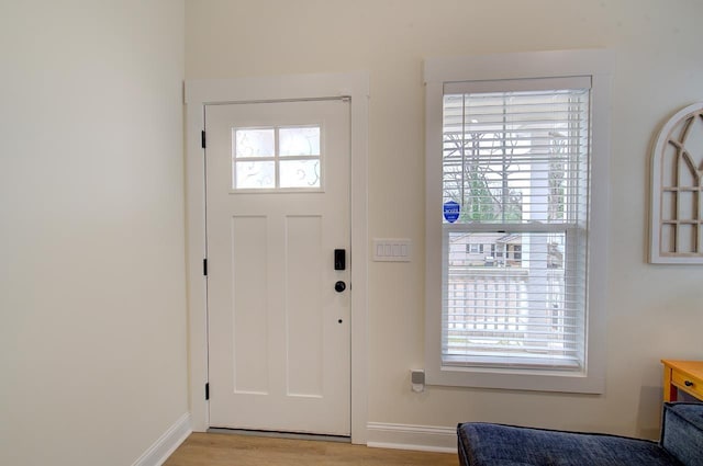 entryway featuring light wood-style flooring and baseboards