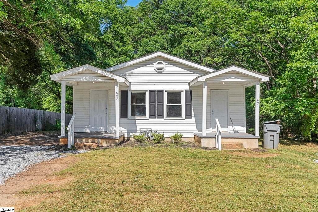 bungalow-style house with a front yard and fence