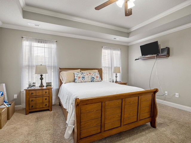 bedroom with carpet floors, a raised ceiling, visible vents, and baseboards