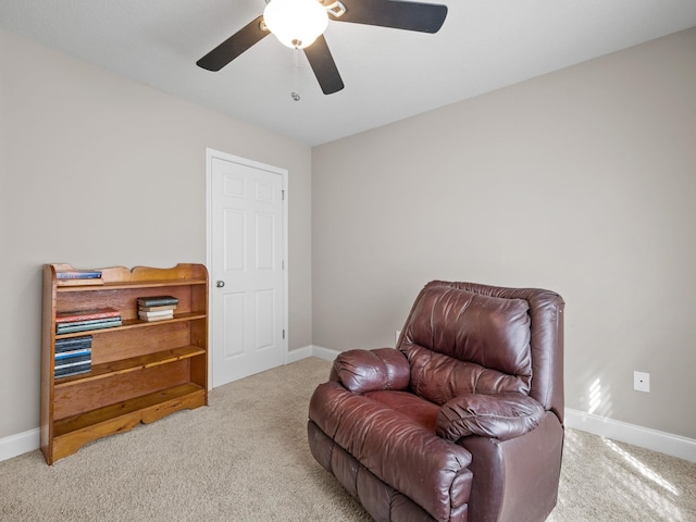 sitting room featuring carpet floors and baseboards