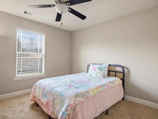 bedroom featuring carpet floors, visible vents, baseboards, and a ceiling fan