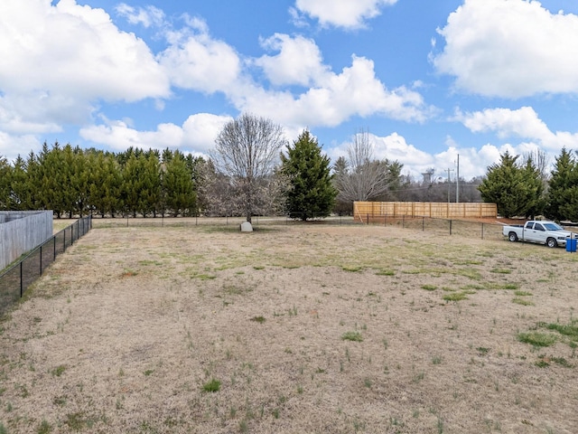 view of yard featuring a rural view and fence