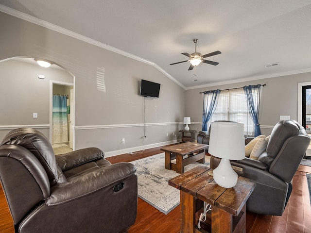 living room featuring arched walkways, wood finished floors, visible vents, vaulted ceiling, and crown molding