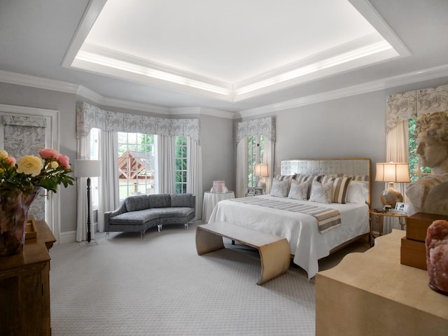 bedroom featuring baseboards, ornamental molding, a raised ceiling, and carpet flooring