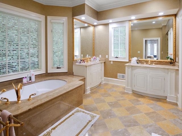 full bathroom featuring two vanities, visible vents, baseboards, a bath, and crown molding