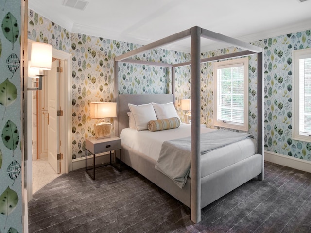 bedroom featuring visible vents, multiple windows, and wallpapered walls