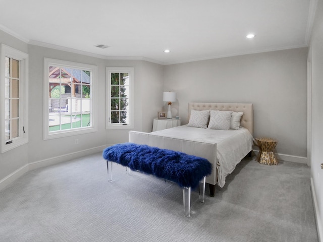 bedroom with ornamental molding, carpet flooring, and baseboards