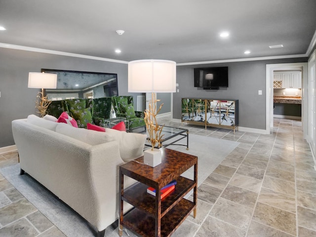 living room with recessed lighting, stone finish flooring, crown molding, and baseboards