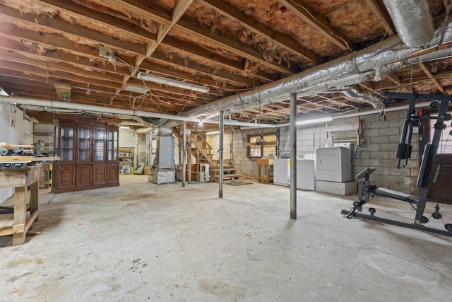 unfinished basement with washing machine and dryer and heating unit