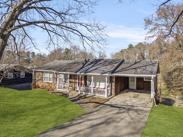 view of front facade with a porch, aphalt driveway, fence, a carport, and a front lawn