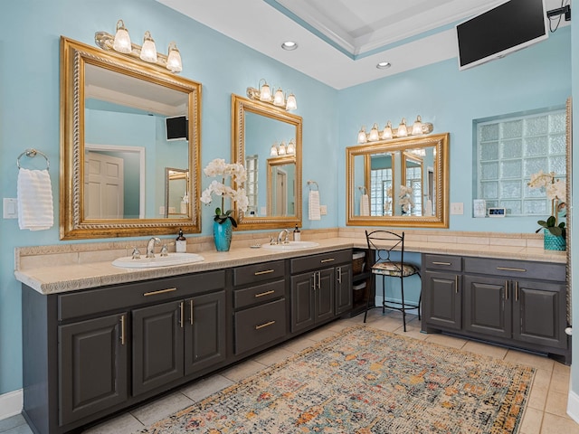 bathroom with recessed lighting, double vanity, a sink, and tile patterned floors