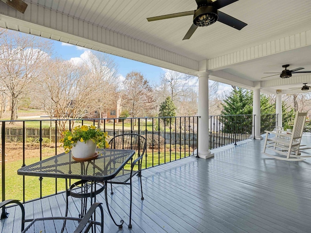 wooden deck featuring ceiling fan