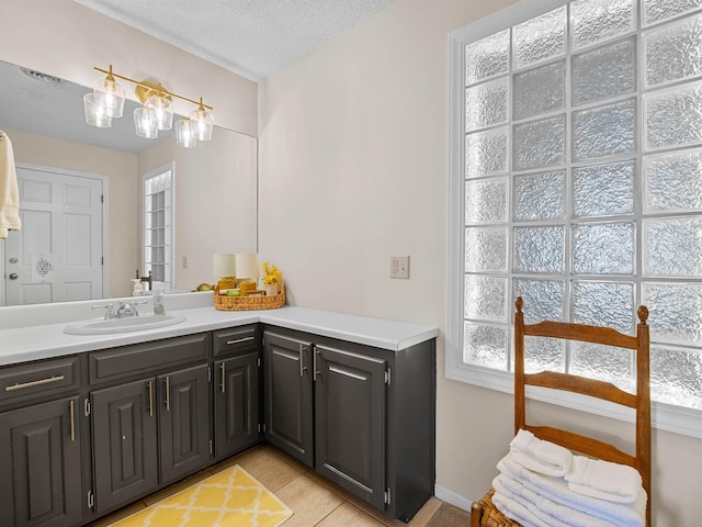 bathroom featuring a textured ceiling, vanity, and tile patterned floors