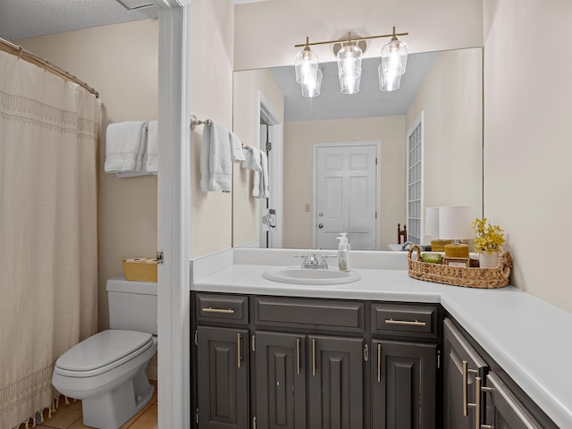 bathroom with toilet, tile patterned floors, and vanity