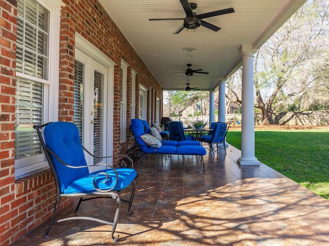 view of patio / terrace with a ceiling fan and fence