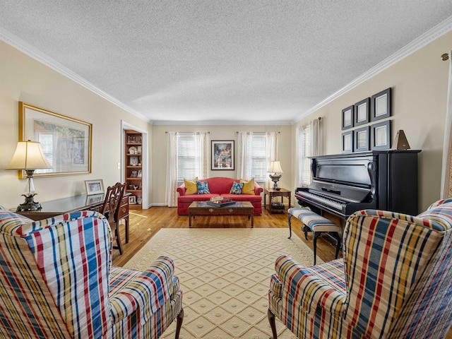 living room with ornamental molding, a textured ceiling, and wood finished floors