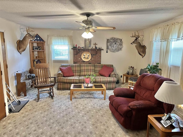 carpeted living area with a ceiling fan and a textured ceiling