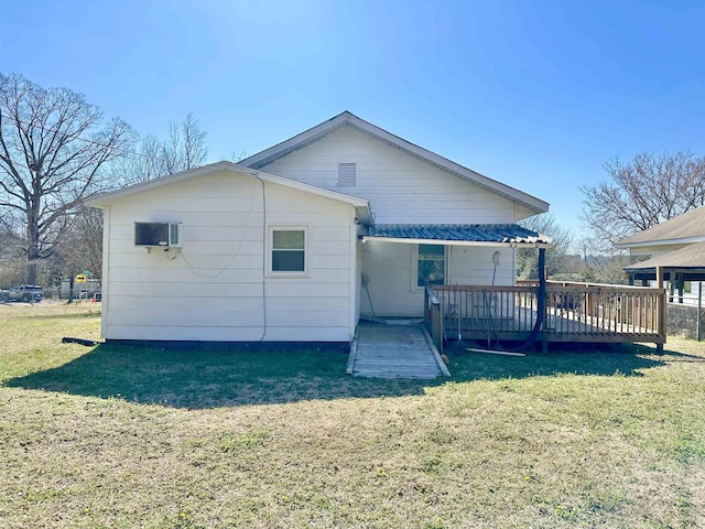 back of house with a deck and a yard