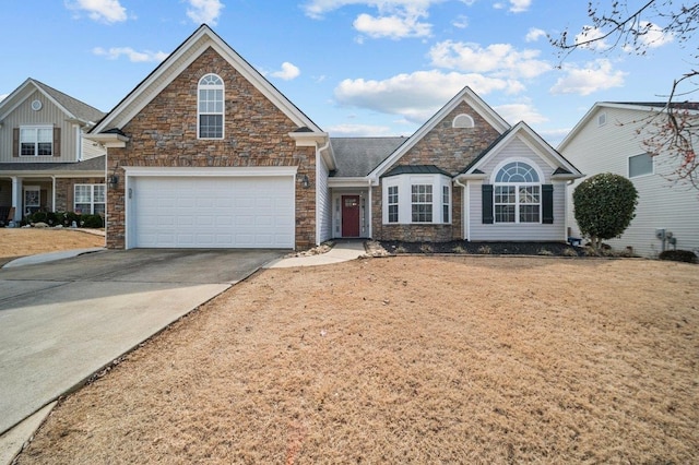 view of front of house featuring a garage, stone siding, and concrete driveway