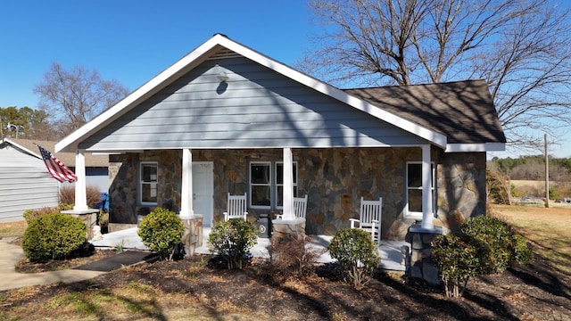 view of front of home featuring a porch and stone siding