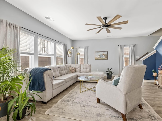 living room featuring ceiling fan, plenty of natural light, and wood finished floors