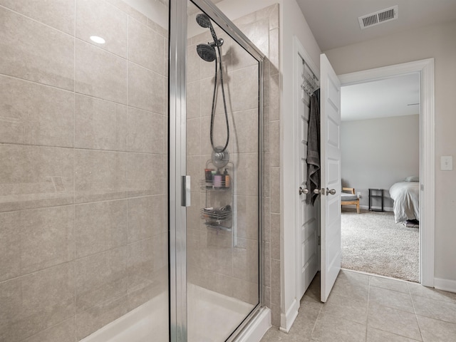 ensuite bathroom with a stall shower, tile patterned flooring, connected bathroom, and visible vents