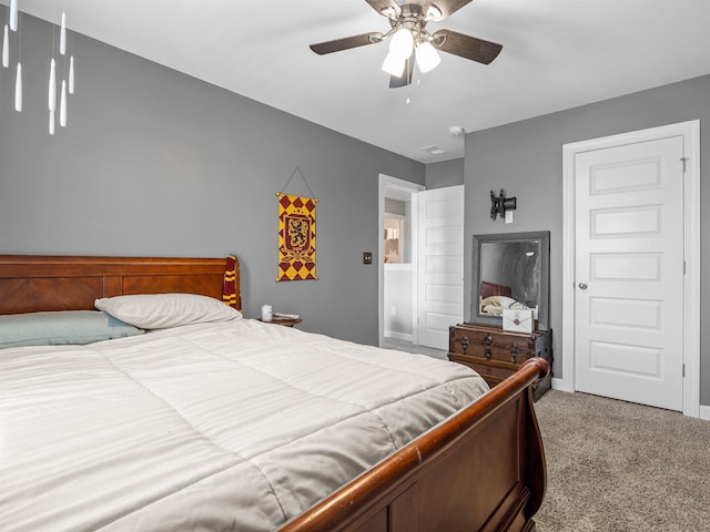 carpeted bedroom featuring ceiling fan and baseboards