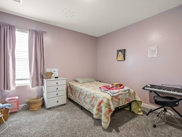 carpeted bedroom featuring baseboards