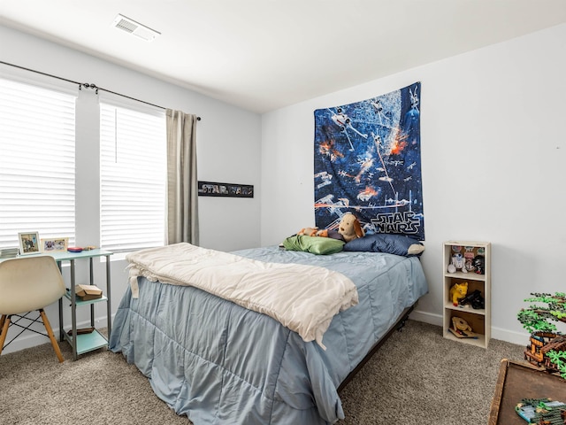 bedroom with baseboards, visible vents, and carpet flooring