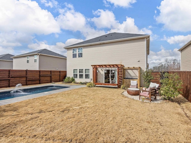 back of property with an outdoor fire pit, a patio area, a fenced backyard, and a fenced in pool