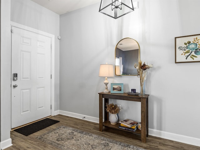 foyer featuring wood finished floors and baseboards