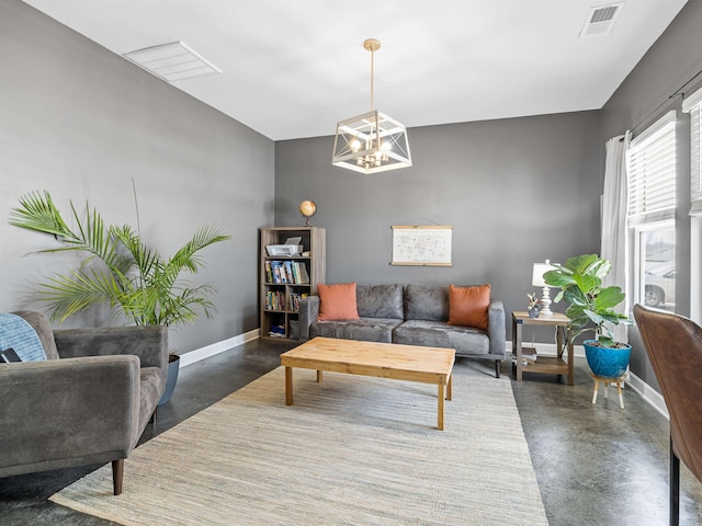 living room with concrete floors, visible vents, and baseboards