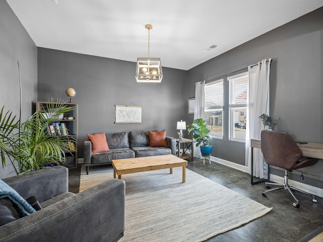 living room with finished concrete flooring, a chandelier, visible vents, and baseboards