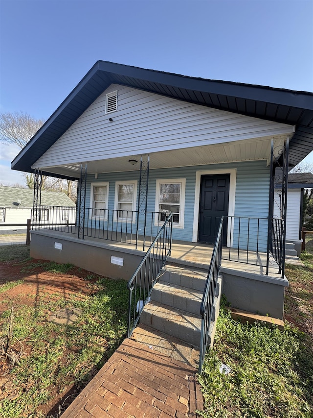 view of front facade with crawl space and a porch