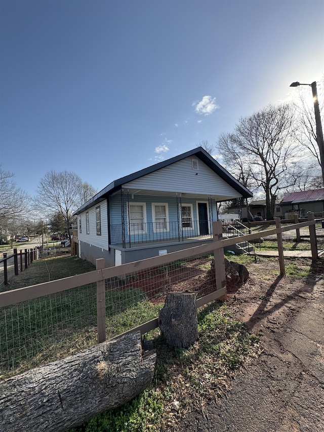 view of front of home featuring fence