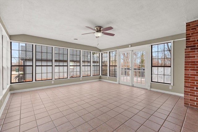 unfurnished sunroom with vaulted ceiling and a ceiling fan