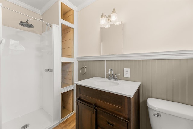 full bathroom featuring ornamental molding, a stall shower, vanity, and toilet