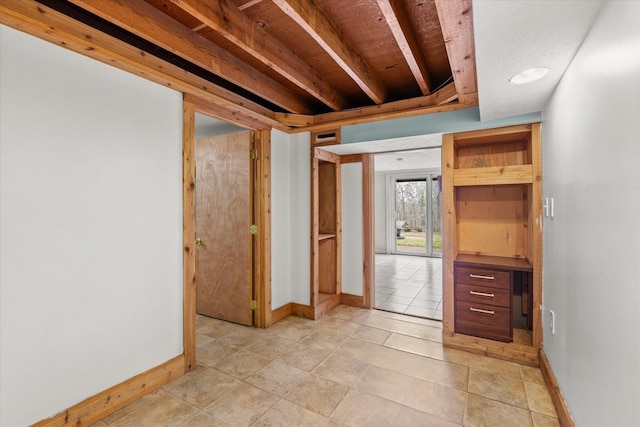 interior space with baseboards and light tile patterned floors