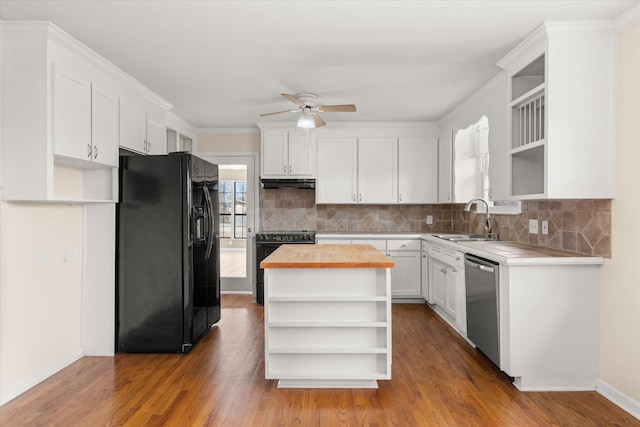 kitchen featuring black appliances, under cabinet range hood, open shelves, and a sink