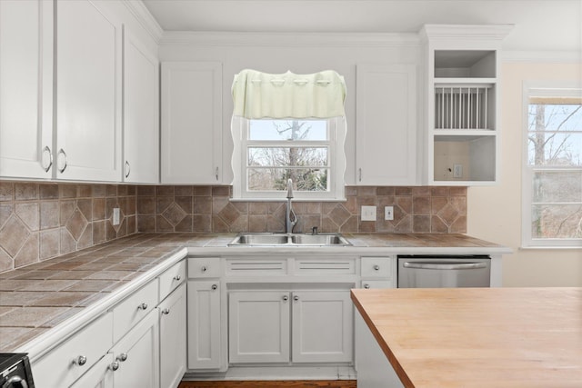 kitchen with tile countertops, open shelves, a sink, plenty of natural light, and dishwasher