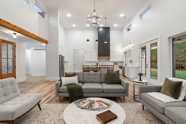 178 Cook, Chesnee, SC 29323 - living area with a towering ceiling, light wood-style flooring, a chandelier, and baseboards