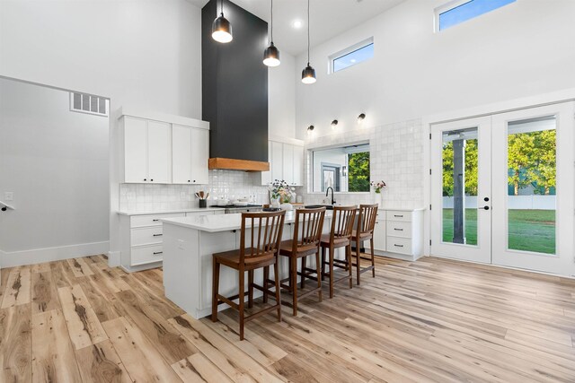 178 Cook, Chesnee, SC 29323 - kitchen featuring a high ceiling, light countertops, a kitchen bar, decorative backsplash, and white cabinetry