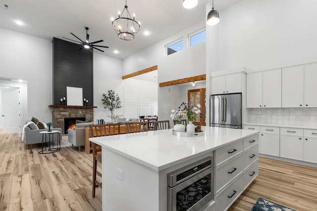 178 Cook, Chesnee, SC 29323 - kitchen with stainless steel appliances, a high ceiling, light wood-style floors, a fireplace, and open floor plan