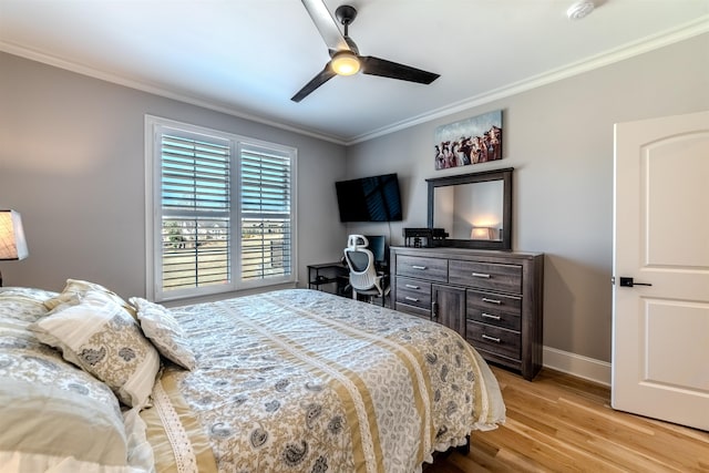 bedroom featuring light wood-type flooring, crown molding, baseboards, and ceiling fan