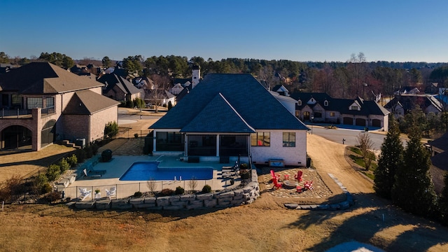 back of house featuring a fenced in pool, a residential view, a fenced backyard, and a patio