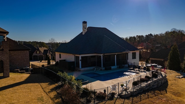 rear view of property featuring a yard, a fenced backyard, a fenced in pool, and a patio